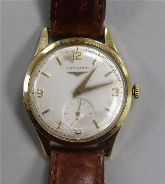 A gentlemans 14ct gold Longines manual wind wrist watch.